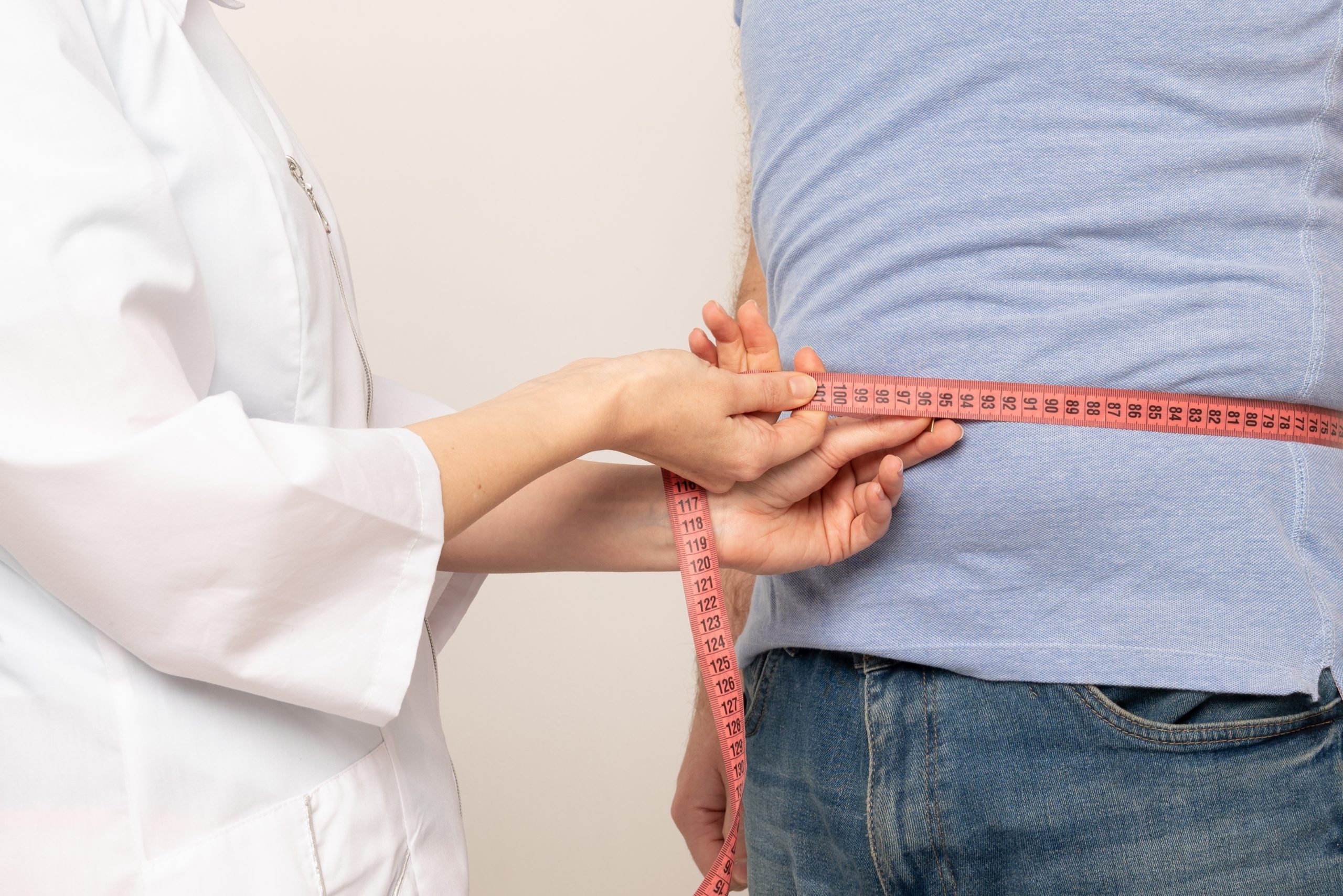 someone measuring mans waist