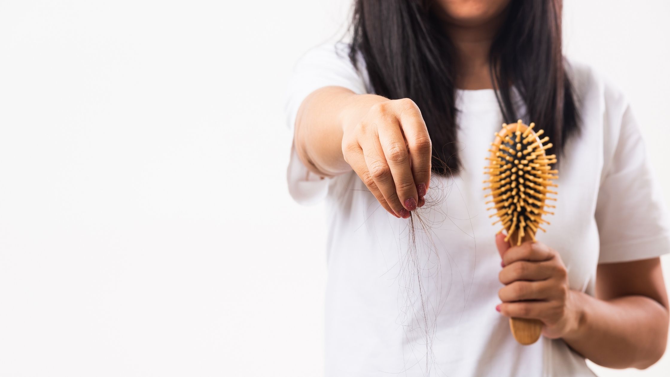lady showing loosing hair when brushing