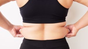 lady showing fat on her waist