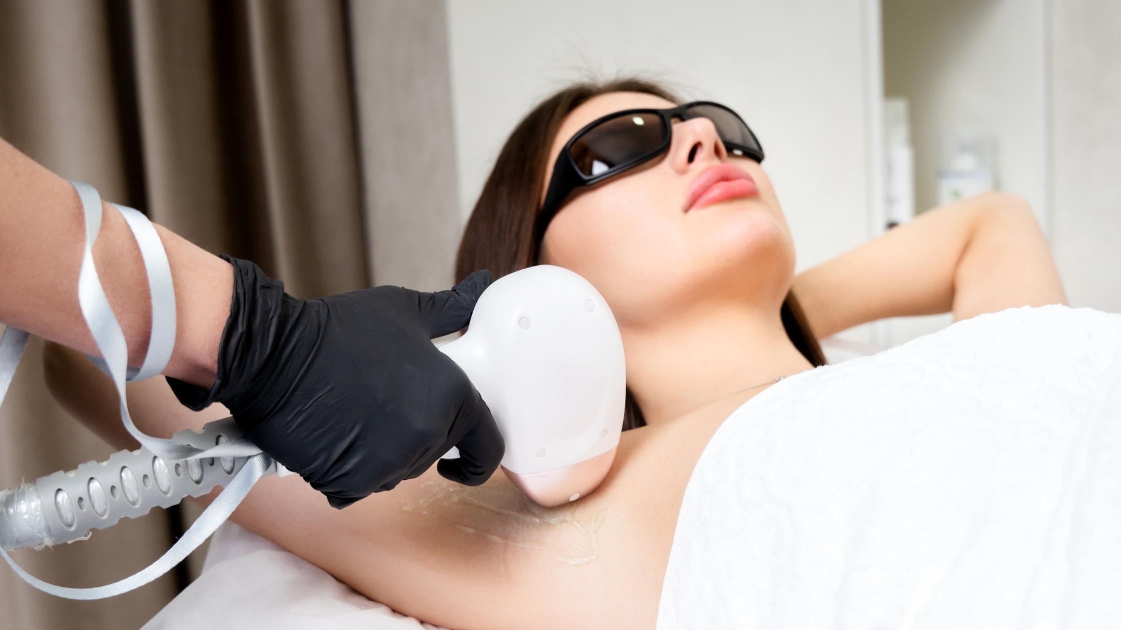 lady receiving laser hair treatment on armpits